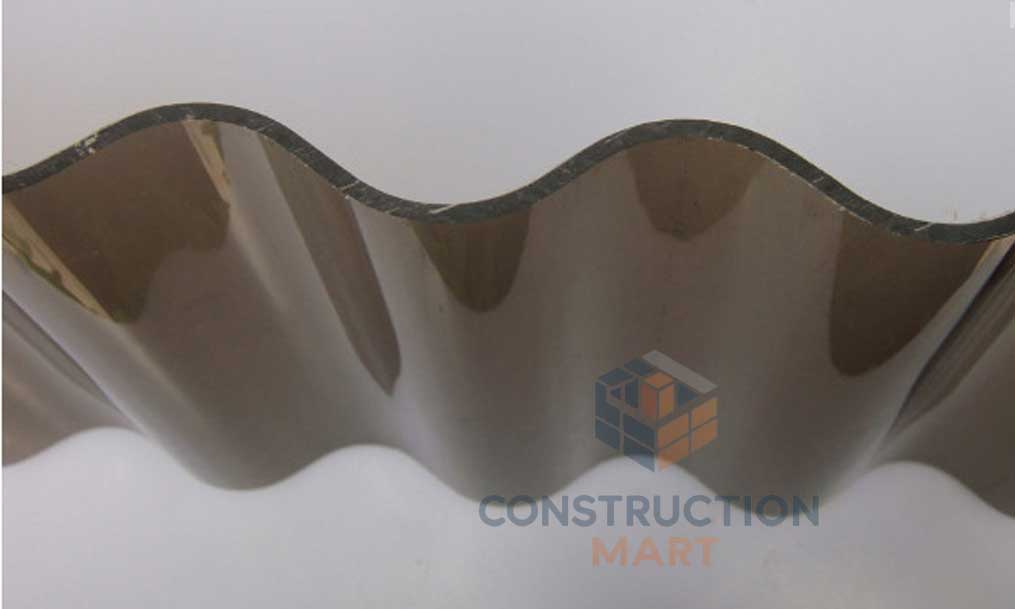 Tea-colored round corrugated polycarbonate sheet sample from Constructionmart, showcasing the unique wave profile.