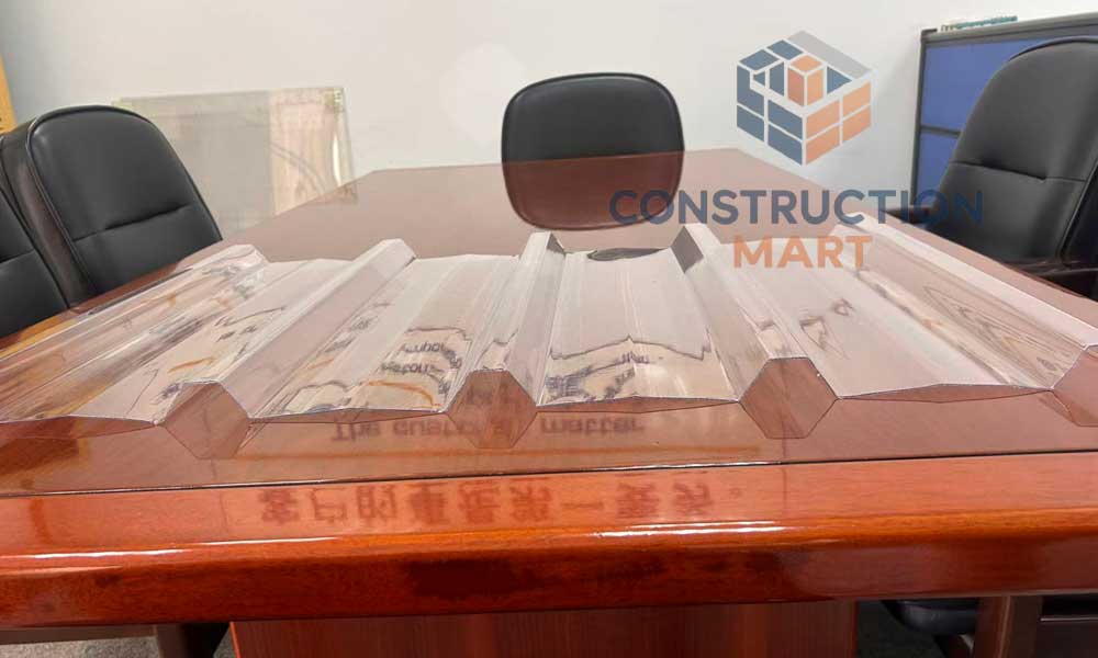 Close-up cross-section of Constructionmart 5-rib corrugated polycarbonate panel showing the trapezoidal ridge structure.