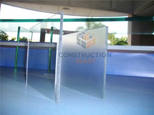 Two black polycarbonate sheets, one frosted and one solid, placed side by side to compare surface textures for interior decorative wall panels.