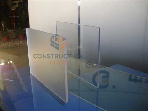  Frosted and solid polycarbonate sheets compared to show strength and texture difference, ideal for protective safety barrier applications.