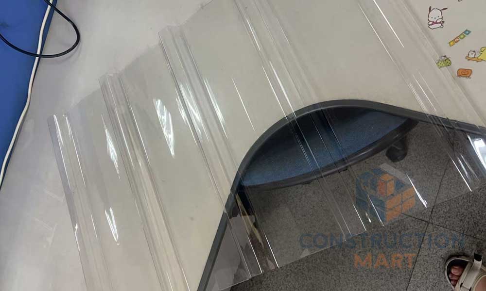 Top angle photo of Constructionmart polycarbonate corrugated sheet with five raised ridges, highlighting its wavy structure and clarity.